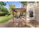 Outdoor patio includes dining set and bench, surrounded by lawn and professional landscaping at 630 W Navarro Ave, Mesa, AZ 85210