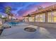 The backyard has a covered patio, pool, and seating at 6550 N 7Th St, Phoenix, AZ 85014