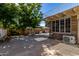 Private backyard featuring a stone patio with mature trees, and access to a brick home at 6550 N 7Th St, Phoenix, AZ 85014