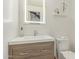 Modern bathroom featuring vanity with a backlit mirror, stylish decor, and tile flooring at 6550 N 7Th St, Phoenix, AZ 85014
