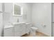 Modern bathroom featuring white cabinets, a lighted mirror, and neutral tile floors at 6550 N 7Th St, Phoenix, AZ 85014
