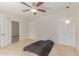Neutral bedroom featuring travertine flooring, ceiling fan, and closet with louvred doors at 6550 N 7Th St, Phoenix, AZ 85014