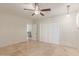 Neutral bedroom featuring tile floors, ceiling fan, closet and access to other rooms at 6550 N 7Th St, Phoenix, AZ 85014