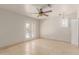 Bright bedroom with tile floor, shutters on the window and a set of french doors to the exterior at 6550 N 7Th St, Phoenix, AZ 85014