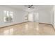 A neutral bedroom with ceiling fan, shutters, and tile floor at 6550 N 7Th St, Phoenix, AZ 85014
