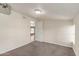 Carpeted bedroom featuring access to additional rooms and a bright light at 6550 N 7Th St, Phoenix, AZ 85014