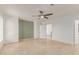 Neutral bedroom featuring travertine flooring, ceiling fan, and painted accent wall at 6550 N 7Th St, Phoenix, AZ 85014