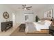 Serene bedroom with a rustic wood bed, barn door access, and modern ceiling fan at 6550 N 7Th St, Phoenix, AZ 85014