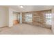Bedroom with brick accent wall, carpeted flooring, and a built-in closet at 6550 N 7Th St, Phoenix, AZ 85014