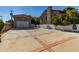Long driveway leading to a detached garage, bordered by brick accents and a privacy fence at 6550 N 7Th St, Phoenix, AZ 85014