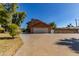 Exterior view of home, showcasing the two-car garage and large driveway at 6550 N 7Th St, Phoenix, AZ 85014