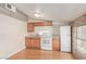 A functional kitchenette offering wood cabinets, essential appliances, and natural light at 6550 N 7Th St, Phoenix, AZ 85014