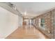 Open-concept living space with hardwood floors, exposed brick, and a bright kitchen at 6550 N 7Th St, Phoenix, AZ 85014