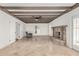 Bright and airy living room with a brick fireplace, exposed ceiling beams, and tile flooring at 6550 N 7Th St, Phoenix, AZ 85014