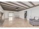 Cozy living room with exposed beam ceiling, stylish fireplace, and tile flooring at 6550 N 7Th St, Phoenix, AZ 85014