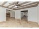 Bright living room featuring a beamed ceiling, tile flooring, and multiple access points at 6550 N 7Th St, Phoenix, AZ 85014