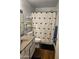 This bathroom features an updated vanity, stylish shower curtain, and ample storage at 696 W Shawnee Dr, Chandler, AZ 85225
