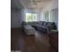 Comfortable living room featuring a large sectional sofa, wood flooring, and natural light at 696 W Shawnee Dr, Chandler, AZ 85225