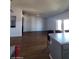 Open concept living room with wood flooring and ceiling fan for a modern and airy feel at 696 W Shawnee Dr, Chandler, AZ 85225