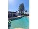 Inviting backyard pool featuring a brick surround, mature trees, and clear blue water, ideal for relaxation and outdoor enjoyment at 696 W Shawnee Dr, Chandler, AZ 85225