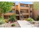 Multi-level apartment building featuring landscaped grounds, inviting pathways, and convenient stair access for residents and guests alike at 8055 E Thomas Rd # C203, Scottsdale, AZ 85251
