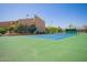 Outdoor tennis court surrounded by fences and landscaping at 8055 E Thomas Rd # C203, Scottsdale, AZ 85251