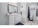Well-lit bathroom with a modern vanity, large mirror, and shower and bath combination at 8055 E Thomas Rd # D111, Scottsdale, AZ 85251