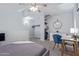 Comfortable bedroom offers closet, ceiling fan, soft lighting and desk with chair at 8055 E Thomas Rd # D111, Scottsdale, AZ 85251