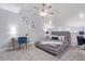 Cozy bedroom with a ceiling fan, natural light, soft carpet, and modern decor at 8055 E Thomas Rd # D111, Scottsdale, AZ 85251
