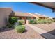 Single-story home featuring desert landscaping, including cacti and succulents, with a walkway to the entrance at 8055 E Thomas Rd # D111, Scottsdale, AZ 85251