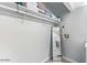 Practical laundry area with storage shelving and a full-length mirror at 8055 E Thomas Rd # D111, Scottsdale, AZ 85251