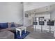 Inviting living room featuring a cozy sofa, counter seating, and open layout to the kitchen and stairs at 8055 E Thomas Rd # D111, Scottsdale, AZ 85251
