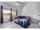 Comfortable living space with couch, ceiling fan, and access to the outdoor patio at 8055 E Thomas Rd # D111, Scottsdale, AZ 85251