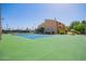 Outdoor tennis court on a sunny day, ready for a match with lush greenery and clear blue skies at 8055 E Thomas Rd # D111, Scottsdale, AZ 85251