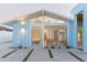 Blue home with modern design featuring an airy entryway and glass doors, enhanced by minimalist desert landscaping at 8308 E Mariposa Dr, Scottsdale, AZ 85251