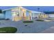 Charming home with desert landscaping and modern architectural details, illuminated with landscape lighting in the evening at 8308 E Mariposa Dr, Scottsdale, AZ 85251