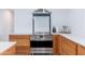 Gourmet kitchen showcasing stainless steel oven and cooktop with custom wood cabinetry at 8308 E Mariposa Dr, Scottsdale, AZ 85251