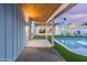 Exterior view shows the pool with lounge chairs, a covered patio, and seamless indoor-outdoor living spaces at 8308 E Mariposa Dr, Scottsdale, AZ 85251