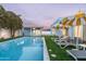 Beautiful backyard oasis with a sparkling pool, lounge chairs, and a well-manicured lawn, ideal for outdoor enjoyment at 8308 E Mariposa Dr, Scottsdale, AZ 85251