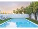 Inviting backyard pool surrounded by lush greenery, lounge chairs, and stylish yellow umbrellas, perfect for relaxation at 8308 E Mariposa Dr, Scottsdale, AZ 85251