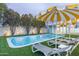 Backyard pool with lounge chairs and a yellow and white umbrella for a relaxing outdoor experience at 8308 E Mariposa Dr, Scottsdale, AZ 85251