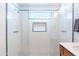 Modern shower with white tile, blue accents, and sleek fixtures in a bright bathroom at 8308 E Mariposa Dr, Scottsdale, AZ 85251