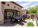 Covered patio and dining area with outdoor grill and water feature, perfect for outdoor entertaining and relaxation at 8974 E Rusty Spur Pl, Scottsdale, AZ 85255