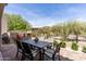 Spacious backyard featuring an outdoor dining area, desert landscaping, and picturesque mountain views. Enjoy outdoor living! at 8974 E Rusty Spur Pl, Scottsdale, AZ 85255