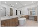 Luxurious bathroom with double vanities, a soaking tub, and modern fixtures with a marble counter at 8974 E Rusty Spur Pl, Scottsdale, AZ 85255