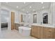 Modern bathroom with dual sink vanity, large soaking tub and big framed mirror at 8974 E Rusty Spur Pl, Scottsdale, AZ 85255