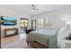 Serene bedroom with a queen bed, a private balcony, and natural light streaming through plantation shutters at 8974 E Rusty Spur Pl, Scottsdale, AZ 85255