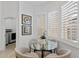Cozy breakfast nook with a glass table, three windows, and comfortable seating for four at 8974 E Rusty Spur Pl, Scottsdale, AZ 85255