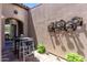 Private courtyard with a charming wall art and an intimate bistro seating area, perfect for enjoying a quiet moment at 8974 E Rusty Spur Pl, Scottsdale, AZ 85255