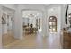 Elegant entryway with light wood floors and arched doorways leading to various rooms at 8974 E Rusty Spur Pl, Scottsdale, AZ 85255